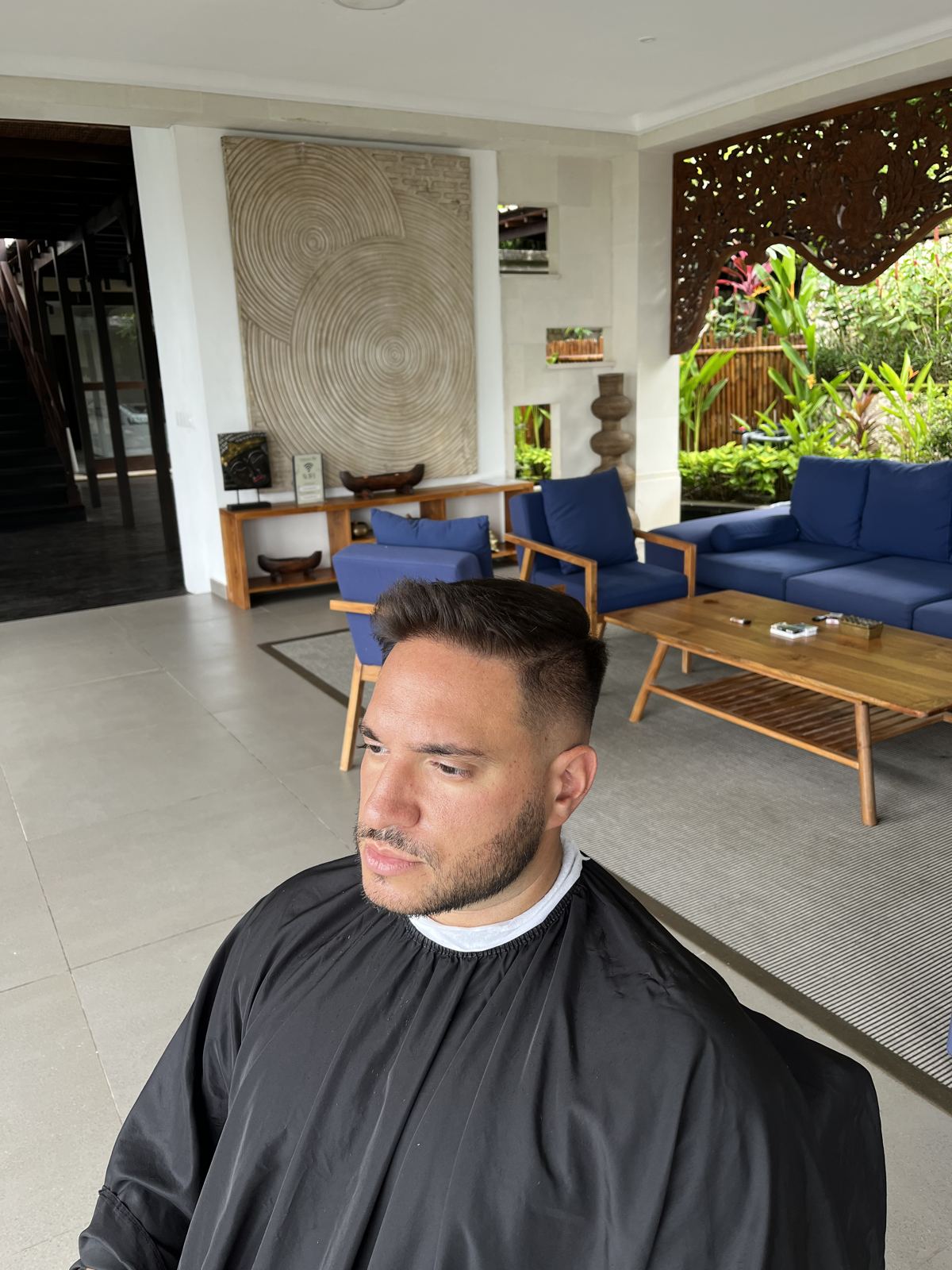 Client in a cape in a hotel lounge